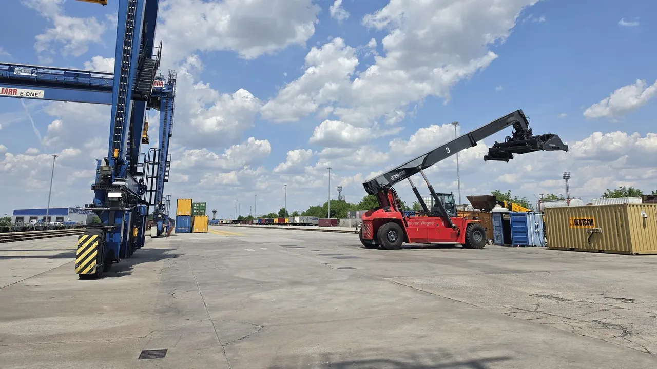 Reachstacker and gantry crane on the handling area of the Arad terminal, with rows of containers behind