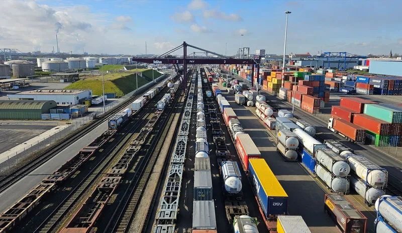 Aerial view of the intermodal terminal at the port of Duisburg: gantry crane over rail tracks, block trains and container rows