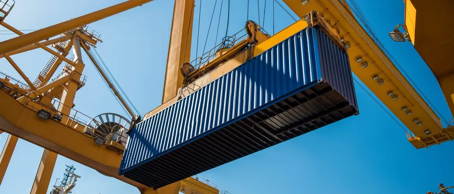 Gantry crane lifting a container above the terminal